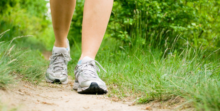 Legs of someone walking on trail